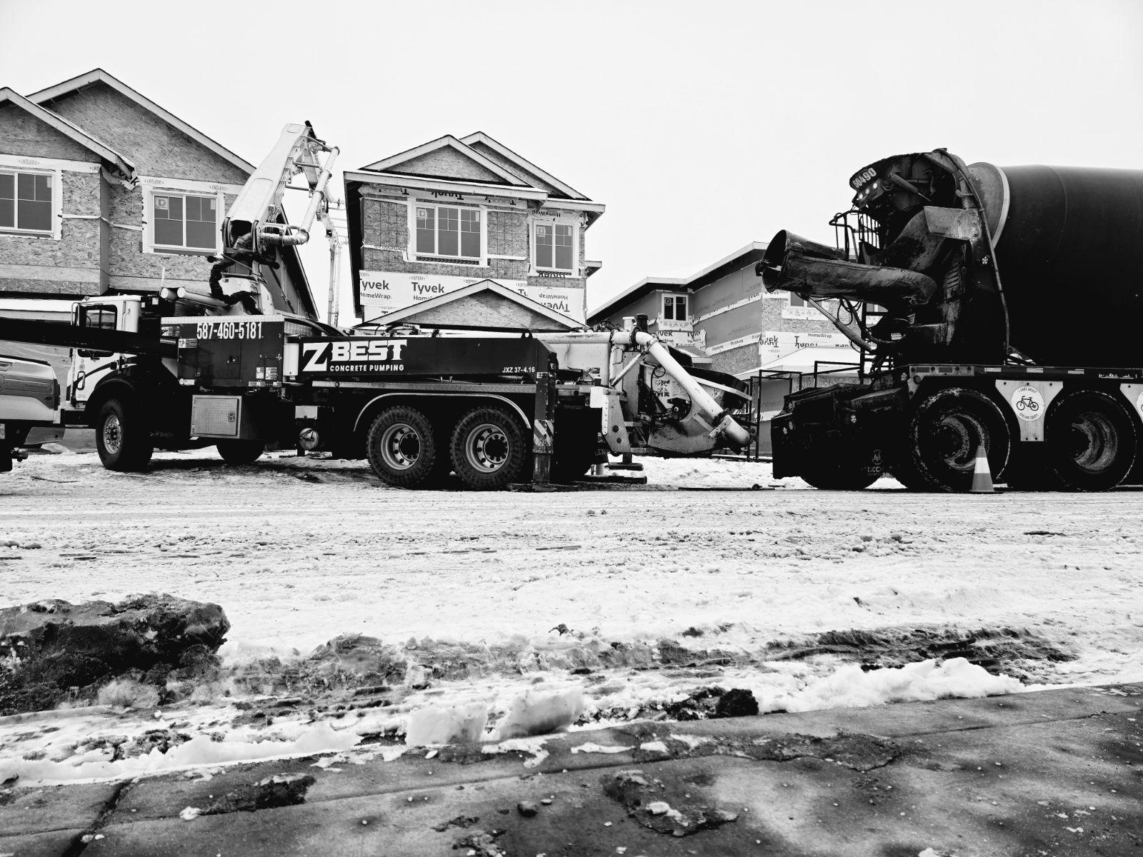 Concrete pump truck boom extended on a construction site in Edmonton